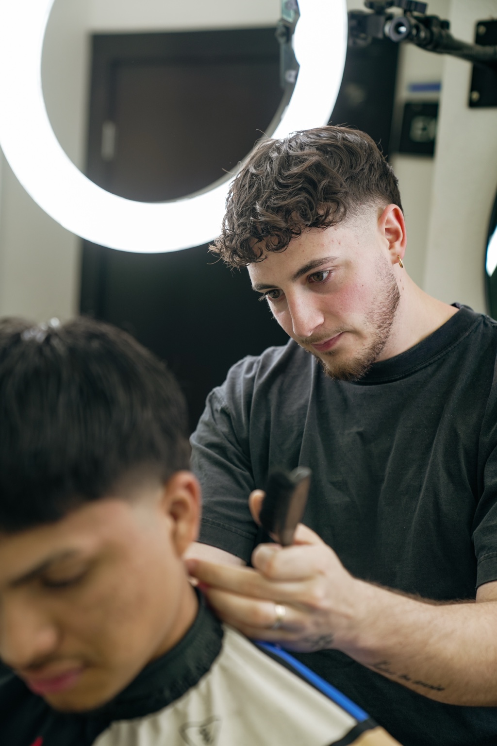 Dathan working with a client in his Austin barbershop